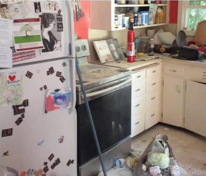 kitchen with fridge, stove, and fire extinguisher on counter