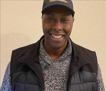 Male Employee wearing Hat with SERVPRO attire 